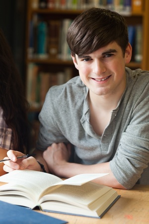 Portrait of a smiling student in a libraryの写真素材