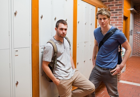 Handsome students standing up in a corridorの写真素材