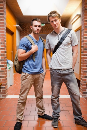 Portrait of handsome students posing in a corridorの写真素材