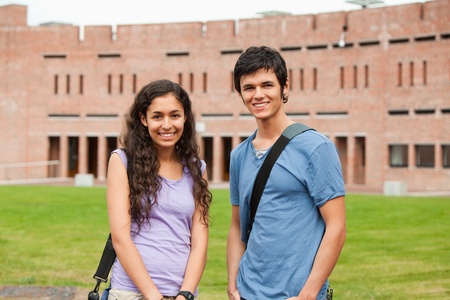Young classmates posing outside a buildingの写真素材