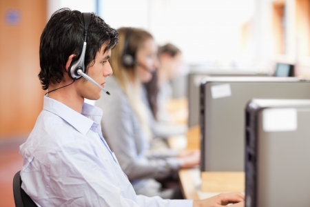 Young operators using a computer in a call centerの写真素材