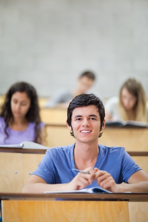 Portrait of focused students during a lecture with the camera focus on the foregroundの写真素材