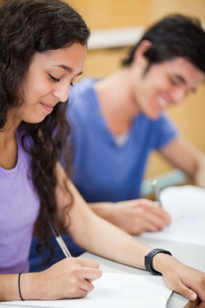 Portrait of students writing in an amphitheaterの写真素材
