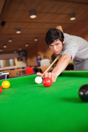 Portrait of a student playing pool in a student homeの写真素材