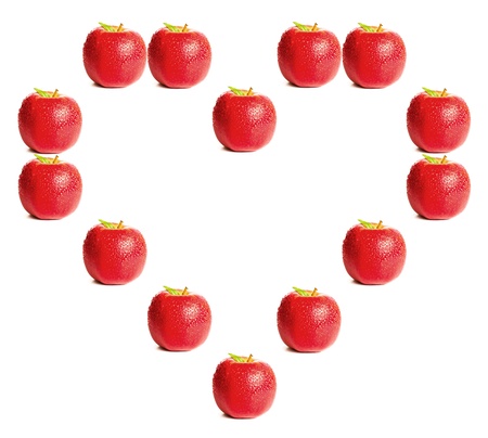 Red apples shaping a heart on white backgroundの写真素材
