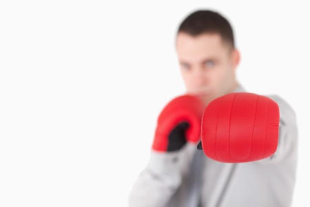 Businessman wearing boxing gloves with the camera focus on the glovesの写真素材