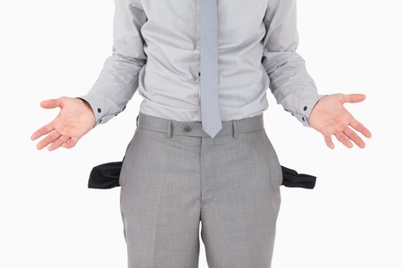 Broke businessman with empty pockets against a white backgroundの写真素材