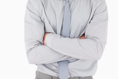 Businessman with his arms crossed against a white backgroundの写真素材