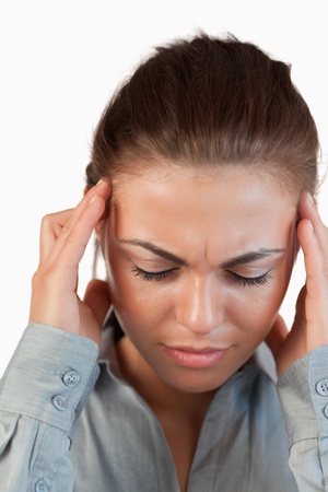 Close up of businesswoman having a headache against a white backgroundの写真素材