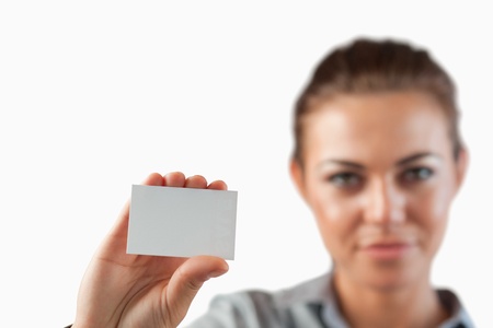 Close up of business card being shown by businesswoman against a white backgroundの写真素材