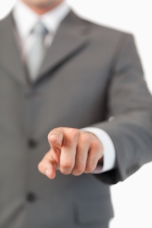 Close up of masculine finger pressing a invisible touchscreen against a white backgroundの写真素材