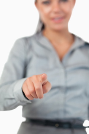 Portrait of a businesswoman pressing an invisible key with the camera focus on her handの写真素材