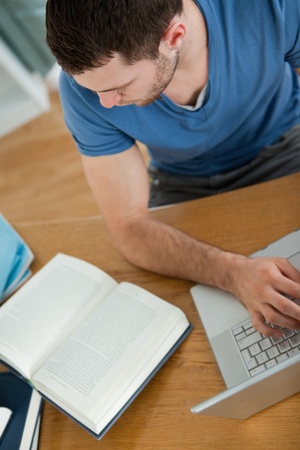 Male student is using the internet to find the right answerの写真素材