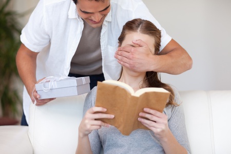 Young man having a surprise for his girlfriendの写真素材