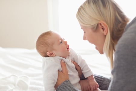 Affectionate young mom holding her newbornの写真素材