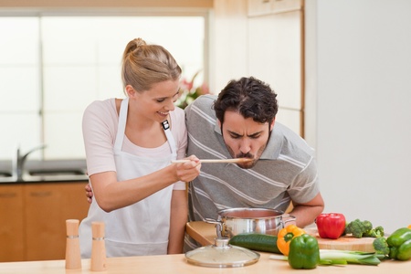 Couple preparing a sauce in their kitchenの写真素材