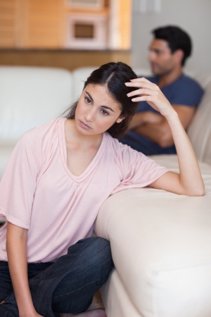 Portrait of a depressed couple after an argument in their living roomの写真素材