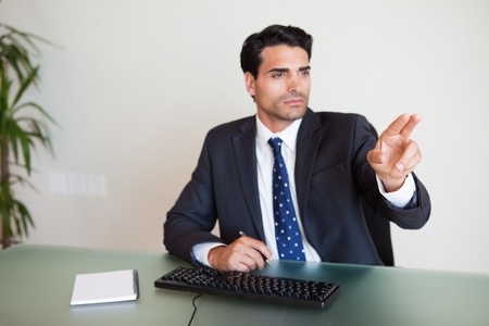 Businessman showing something in his officeの写真素材