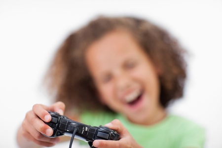 Smiling girl playing a video game against a white background