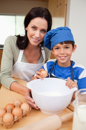 Son and mother baking cake togetherの写真素材