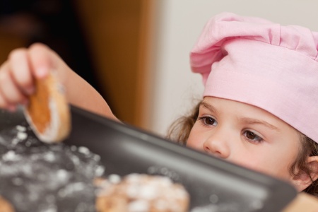 Young girl stealing a cookieの写真素材