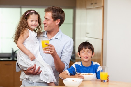 Father having breakfast together with his kidsの写真素材