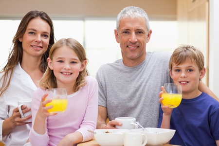 Happy family having breakfast in their kitchen