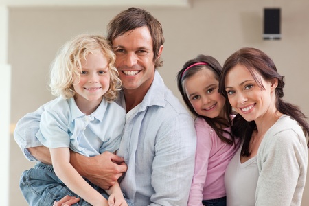 Lovely family posing while looking at the cameraの写真素材