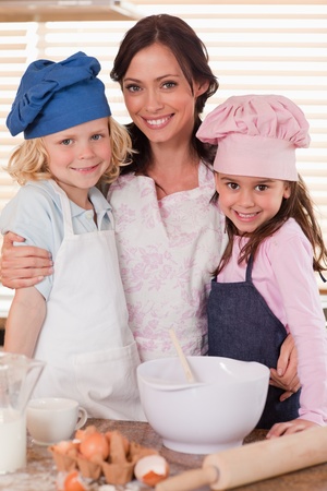 Portrait of a mother and her children baking in a kitchenの写真素材