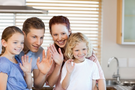 Family waving with their hands togetherの写真素材
