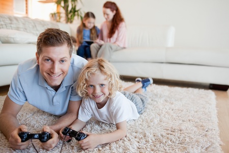 Father and son on the floor playing video games together