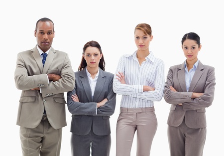 Business team side by side crossing their arms against white backgroundの写真素材