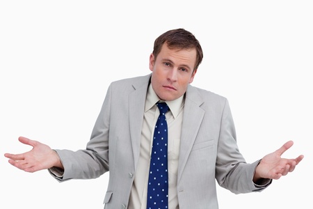 Close up of clueless businessman against a white backgroundの写真素材