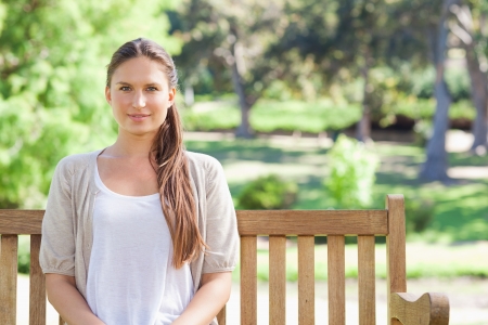 Young woman sitting on a park benchの写真素材
