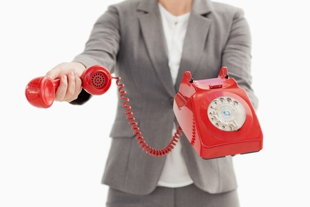 A business person is holding a phoneの写真素材