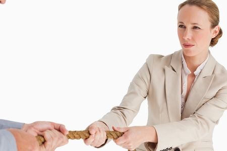 Businesswoman pulling the rope against white backgroundの写真素材