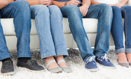 People sitting on the couch with the camera shot on their feet 