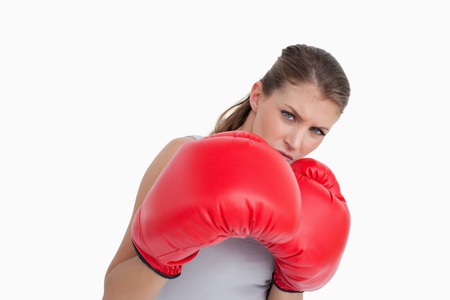 Sports woman boxing against a white background