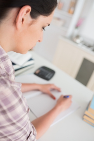 Focus on a woman working in a living roomの写真素材