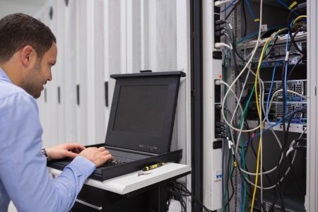 Man working with servers in data centerの写真素材