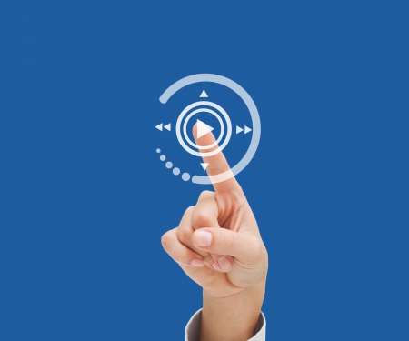 Finger selecting play button blue backgroundの写真素材