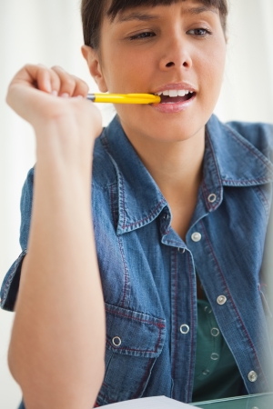 Student grimacing while doing her homework with her laptopの写真素材