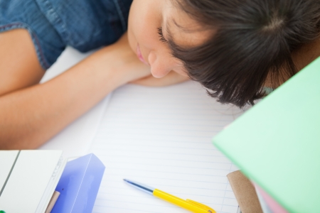 High shot of a female student sleeping on her deskの写真素材