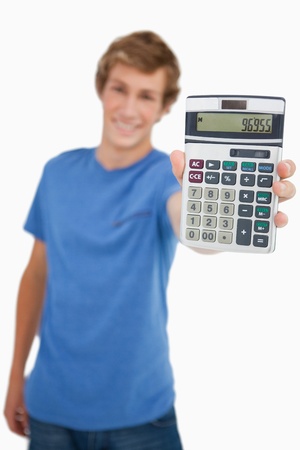 Young man showing a calculator against white backgroundの写真素材