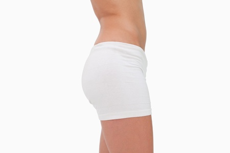Side view of slim hips against white background
