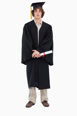 Student in graduate robe against white backgroundの写真素材