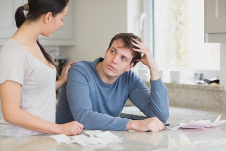 Two people in the kitchen are calculating the financial businessの写真素材