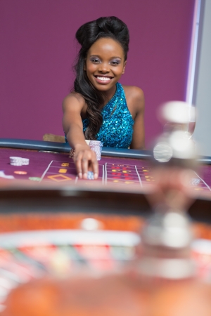 Woman playing roulette at a casinoの写真素材