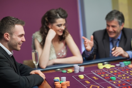 Men and woman talking at craps game in casinoの写真素材