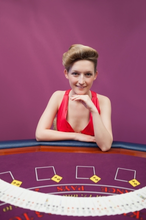 Woman at poker table with spread deck in casinoの写真素材